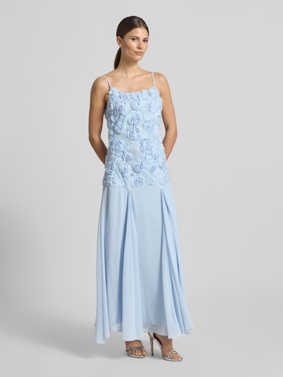 Modelka nosi długą sukienkę Regular Fit Maxikleid mit floralem Besatz Modell 'Feodora' od YAS w jasnoniebieskim kolorze, cienkie ramiączka, dopasowany krój z kwiatowym obszyciem, plisy, halka pod spódnicę, szerokość w rozmiarze 36: 34 cm, długość tyłu: 122 cm, zdjęcie całej sylwetki z przodu.