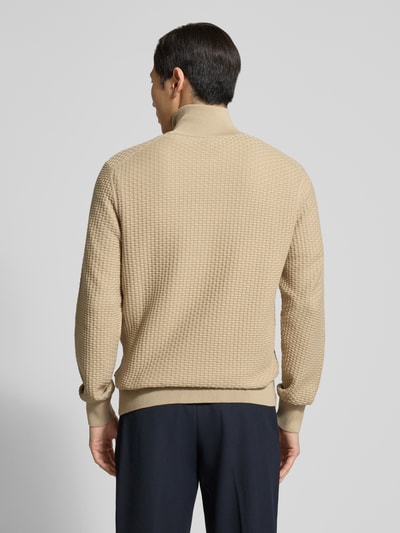 Männermodel trägt Regular Fit Troyer aus reiner Baumwolle Modell 'H-ULICIO' von BOSS, beige, strukturierte Strickoptik, Ganzkörperansicht Rückansicht.