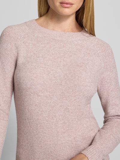 Frauenmodel trägt Regular Fit Pullover mit Rundhalsausschnitt Modell 'DOFFY' von VERO MODA in zartem Rosaton, weiche Stricktextur, Nahaufnahme Oberkörper, Damen Pullover von VERO MODA