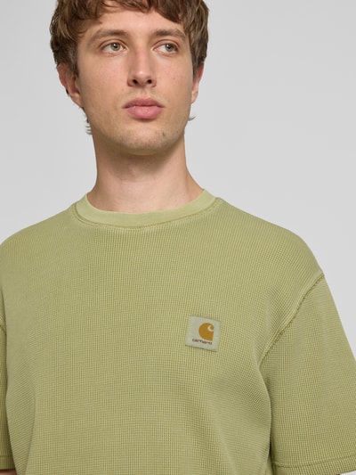 Männermodel trägt Herren T-Shirt mit Strukturmuster Modell 'Nelson' von Carhartt Work In Progress aus reiner Baumwolle, Relaxed-Fit, Label-Detail, Rundhalsausschnitt, Rückenlänge bei Größe M 70 cm, Nahaufnahme Oberkörper