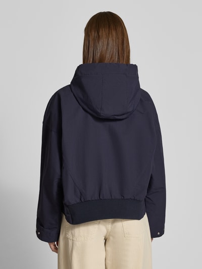 Frauenmodel trägt Regular Fit Parka aus Baumwoll-Mix von Marc O'Polo Denim, efekt: jednolity kolor, krój regular fit, kaptur z tunel, zamek błyskawiczny, wyhaftowane logo, długi rękaw, zakończenie rękawów regulowane zatrzaskami, tunel u dołu, kieszenie z patką, mieszanka bawełny. Ganzkörperansicht Rückansicht.