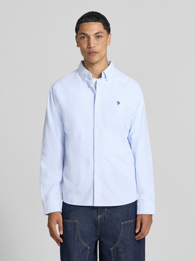 Męski model nosi koszulę casualową z bawełny REVIEW w jasnoniebieskim kolorze, prosty krój, Kołnierzyk typu button down, wyhaftowane logo, mankiety zapinane na 1 guzik, długość tyłu w rozmiarze M: 73 cm, szerokość ramion w rozmiarze M: 44 cm, długość rękawów w rozmiarze M: 67 cm, widok całej sylwetki z przodu.