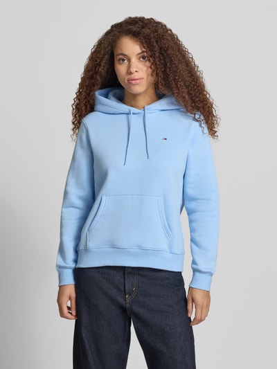 Frauenmodel trägt Regular Fit Hoodie aus Baumwoll-Mix von Tommy Jeans, Optik: Unifarben, Logo-Stitching, Sweat, Ganzkörperansicht von vorne.