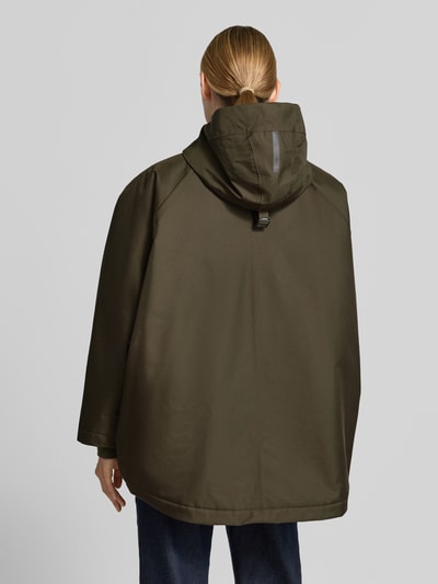 Frauenmodel trägt Relaxed Fit Mantel mit Kapuze Modell 'PURE' von g-lab in Olivgrün, glatte Textur, Rückenansicht, Ganzkörperansicht von hinten, Damen Mantel mit Tunnelzug, Eingrifftaschen, Rückenlänge 69 cm, Schulterbreite 45 cm, Brustweite 88 cm, Ärmellänge 60 cm.