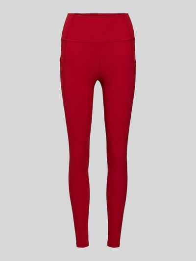 Produktfoto, rote Slim Fit Leggins mit Beintaschen und breitem Bund Modell 'OASIS' von Fabletics, elastischer Material-Mix, schlichte Optik