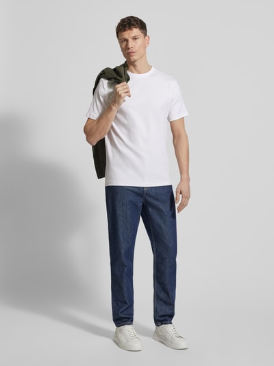 Männermodel trägt Regular Fit T-Shirt aus Baumwoll-Mix Modell 'SPENCER' von SELECTED HOMME in Weiß, gestreift strukturiert, Ganzkörperansicht von vorne.