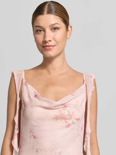 Frauenmodel trägt Maxikleid aus Mesh Modell 'Adelle' von Neo Noir in zartem Rosa mit Allover-Blumenmuster, Rüschen, Nahaufnahme Oberkörper.