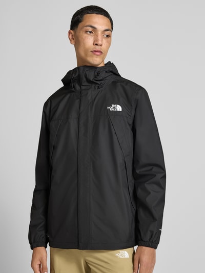 Männermodel trägt schwarze Jacke mit Label-Print Modell 'ANTORA' von The North Face, glatte Oberfläche, Ganzkörperansicht von vorne.