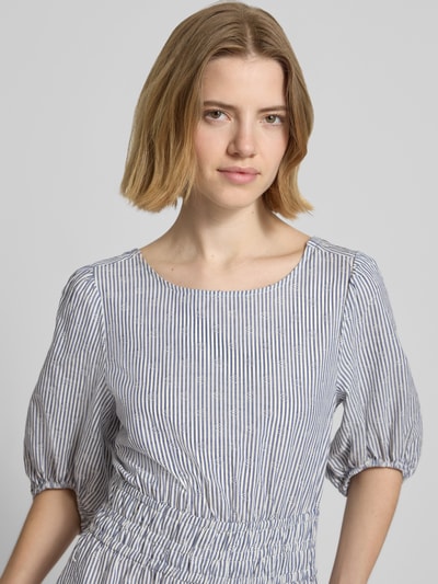 Vrouwenmodel draagt Tailliertes Freizeitkleid aus reiner Baumwolle Modell 'CHIA' van Pepe Jeans met allover-patroon, U-boothals, pofmouwen, elastische mouwafsluiting, rechte zoom en zijzakken van zuiver katoen, nahaufnahme bovenlichaam.