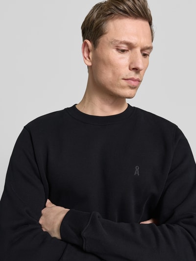 Männermodel trägt Regular Fit Sweatshirt aus reiner Bio Baumwolle Modell 'BAARO FLEECE' von Armedangels, Optik: Unifarben, Logo-Detail, Rundhals, Langarm, Sweat, Nahaufnahme Oberkörper.