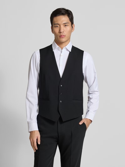 Męski model nosi Regular Fit Anzugweste aus Woll-Mix Modell 'VIN253X-MH' od HUGO, efekt: jednolity kolor, mieszanka wełny, fason/krój: regular fit, detal: ściągacz w talii, dekolt w serek, listwa guzikowa jednorzędowa, kieszenie z wypustką, Ganzkörperansicht von vorne.