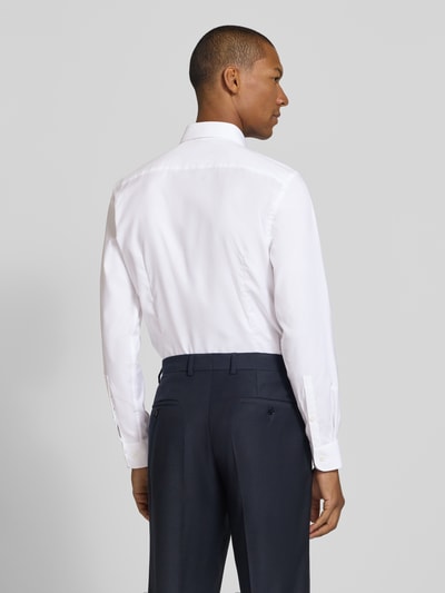 Männermodel trägt weißes Slim Fit Businesshemd aus Baumwoll-Mix von Jake*s zu dunkler Hose, Ganzkörperansicht Rückansicht.