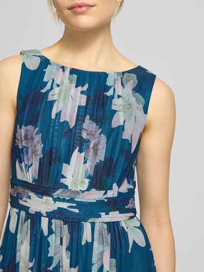 Frauenmodel trägt Cocktailkleid mit Taillenband von Christian Berg Cocktail, floraler Druck, Elastischer-Material-Mix, Nahaufnahme Oberkörper.