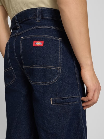 Männermodel trägt Loose Fit Bermudas mit steekzakken van Dickies, denim uit puur katoen, detailaufnahme achterkant.