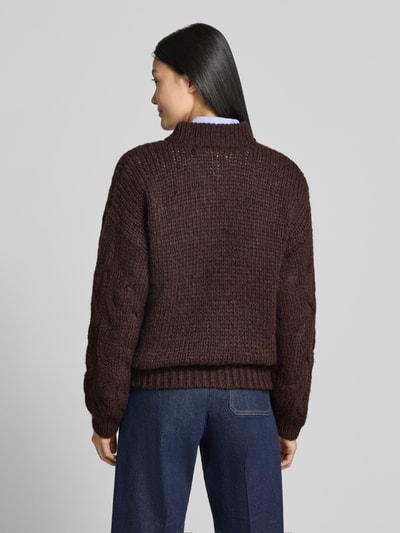Frauenmodel trägt Regular Fit Pullover mit Rundhalsausschnitt Modell 'MAYBE' von VERO MODA in Dunkelbraun, grobe Strickstruktur, Ganzkörperansicht Rückansicht.