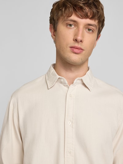 Mężczyznamodel nosi Regular Fit Freizeithemd aus reiner Baumwolle von G-Star Raw w kolorze jasnobeżowym, kołnierzyk typu kent, listwa guzikowa, koszula casualowa, kontekst: bawełna, krój regular fit, długość tyłu w rozmiarze M: 74 cm, szerokość ramion w rozmiarze M: 45 cm, długość rękawów w rozmiarze M: 67 cm, zbliżenie na górną część tułowia