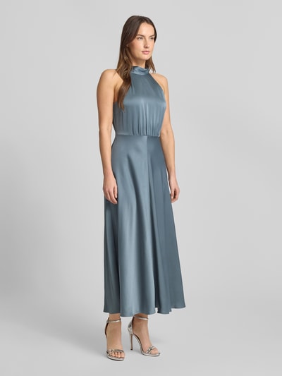 Frauenmodel trägt Maxikleid mit Neckholder Modell 'RHEO' von Samsøe Samsøe in seidig schimmerndem Blau, taillierter Schnitt, Ganzkörperansicht von vorne.
