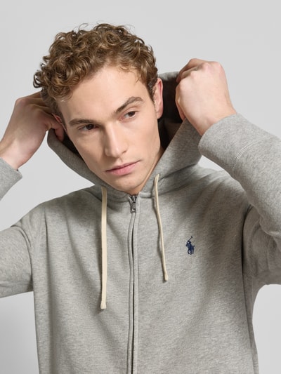 Männermodel trägt Sweatjacke mit Kapuze von Polo Ralph Lauren im Baumwoll-Mix, Lockerer-Schnitt, Label-Stitching, Nahaufnahme Oberkörper.