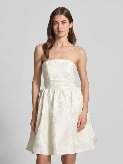 Frauenmodel trägt Minikleid mit floralem Allover-Stitching von Hey Kyla in Creme mit Zierschleife, taillierter Passform, ausgestelltem Rock, abnehmbare Träger, Rückenlänge bei Größe 36: 85 cm, Brustweite bei Größe 36: 34 cm; Nahaufnahme Oberkörper.