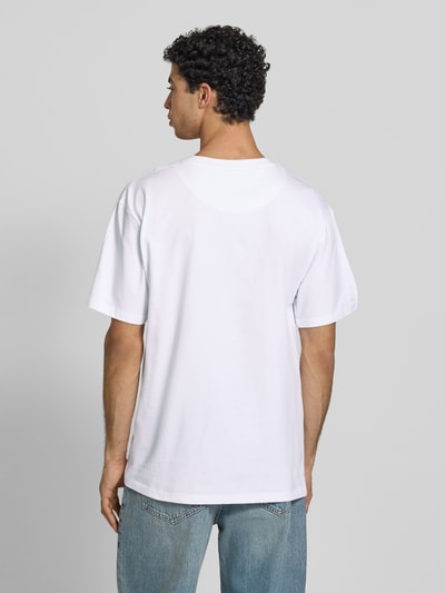 Männermodel trägt Oversized T-Shirt mit Logo-Stitching von KARL KANI aus Reine Baumwolle, Oversized-Fit, Rundhalsausschnitt, Rückenlänge 72 cm, Ganzkörperansicht Rückansicht.