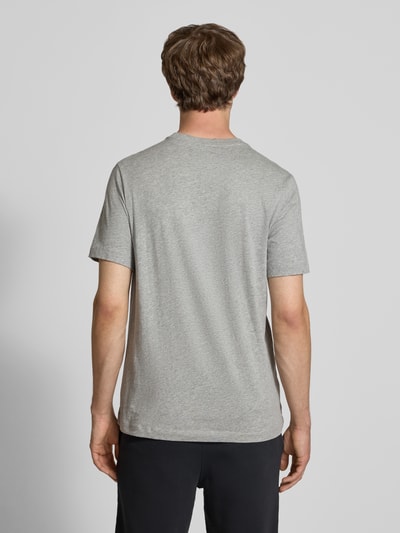 Männermodel trägt T-Shirt mit Label-Stitching von Nike aus Reine Baumwolle, Regular-Fit, Rundhalsausschnitt, Rückenlänge 73 cm, Ganzkörperansicht Rückansicht.