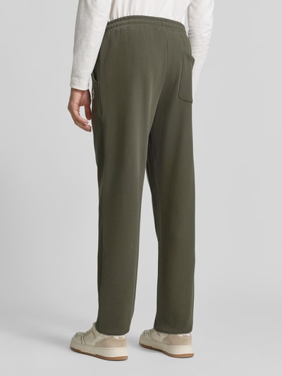 Männermodel trägt Sweatpants mit elastischem Bund und Tunnelzug von Scotch & Soda, reine Baumwolle, Regular Fit, Rückansicht, KI-modifiziertes Bild.