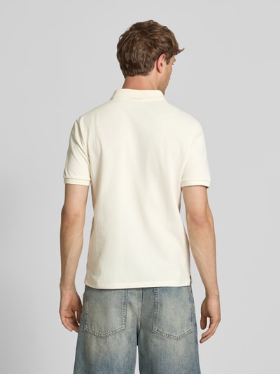 Männermodel trägt Modern Fit Poloshirt mit Logo-Stitching von REVIEW aus Baumwoll-Mix, kurze Knopfleiste, Rückansicht Ganzkörperansicht.