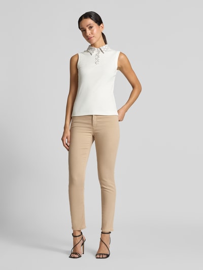 Frauenmodel trägt Flared Fit Jeans mit Lyocell-Anteil von Marc Cain, Damen Jeans im 5-Pocket-Design, beige Töne, elastischer Material-Mix, Ganzkörperansicht von vorne.