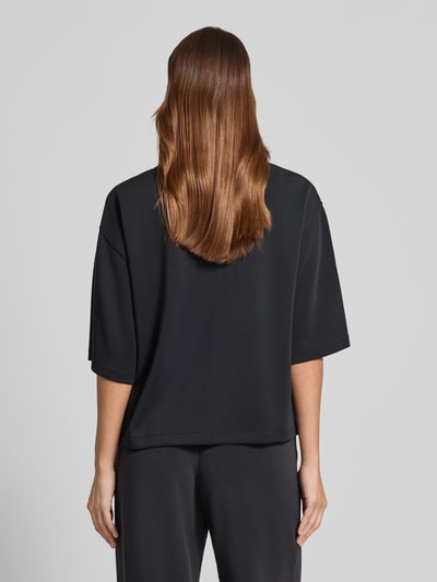Modelka prezentuje damski t-shirt z mieszanki modalu z okrągłym dekoltem od Jake*s Casual, czarny, krój relaxed fit, widok całej sylwetki z tyłu.
