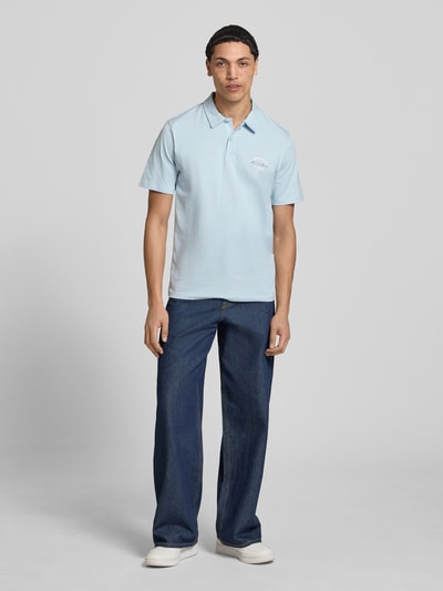 Männermodel trägt Poloshirt mit Label-Print Modell 'BRANDON' von Jack & Jones, Reine Baumwolle, Regular-Fit, Polokragen, Knopfleiste, Hellblau, Rückenlänge bei Größe M 71 cm, Ganzkörperansicht von vorne.