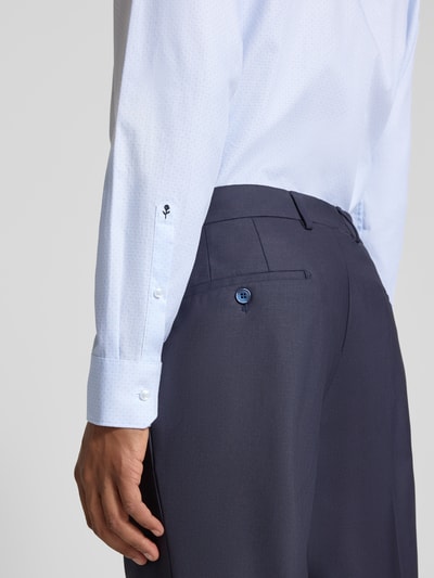 Männermodel trägt Regular Fit Businesshemd aus reiner Baumwolle von Seidensticker in Hellblau zu dunkelblauer Hose, Nahaufnahme Oberkörper. Herren Businesshemd von Seidensticker