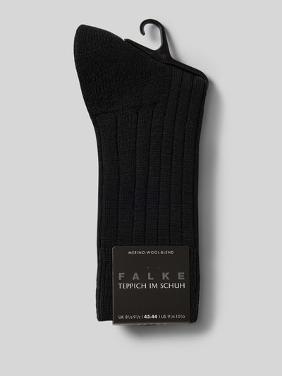 Produktfoto, schwarze Strümpfe aus Schurwollmischung Modell 'Teppich im Schuh' von FALKE mit Rippenstruktur und gepolsterter Sohle.