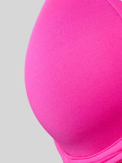 Frauenmodel trägt Bügel-BH mit Herz-Ausschnitt Modell 'Tom' von Marie Jo in Pink, glatte Struktur, Material-Mix mit Stretch, Nahaufnahme Oberkörper.