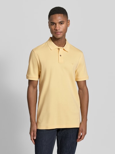 Männermodel trägt Regular Fit Poloshirt mit Logo-Stitching von Fynch-Hatton, reine Baumwolle, Polokragen, Knopfleiste, Ganzkörperansicht von vorne.
