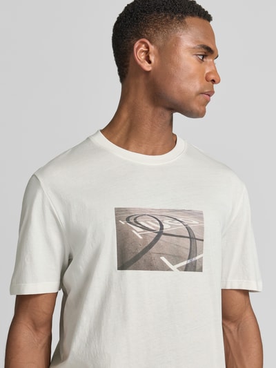 Männermodel trägt Relaxed Fit T-Shirt aus reiner Baumwolle Modell 'DOSTINO' von HUGO, Optik: Unifarben, Label-Print, Rundhals, Ärmelform: Kurzarm, Materialverarbeitung: Jersey, Ganzkörperansicht von vorne.
