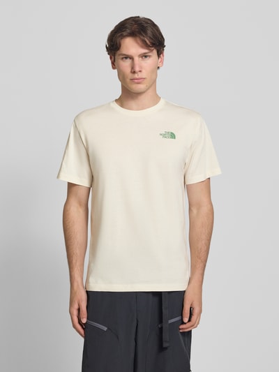 Männermodel trägt T-Shirt mit Logo und Rundhalsausschnitt von The North Face aus Baumwoll-Mix, Regular-Fit, cremefarben, Rückenlänge 72 cm, Ganzkörperansicht von vorne.