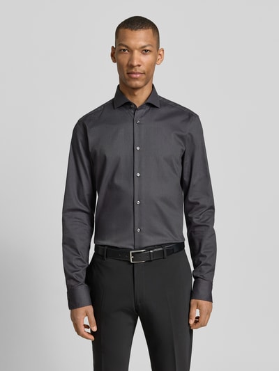 Männermodel trägt Regular Fit Businesshemd mit extralangem Arm Modell 'H-JOE-SPREAD' von BOSS, unifarben, Kentkragen, Ganzkörperansicht von vorne.