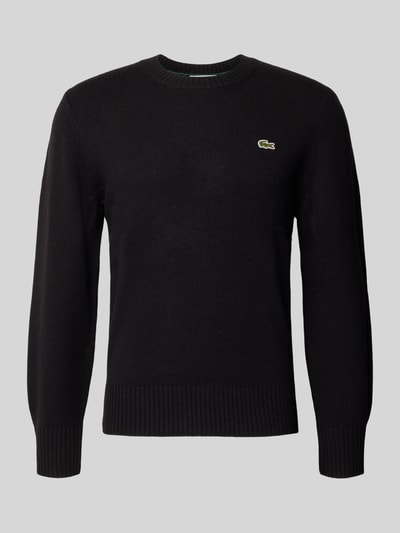 Produktfoto, schwarzer Regular Fit Pullover aus reiner Wolle von Lacoste, dezentes Krokodil-Logo, feine Stricktextur, Herren Pullover