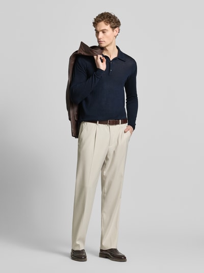 Männermodel trägt donkerblauw Slim Fit Poloshirt uit pure wol Modell 'Eross' van Tiger Of Sweden, polo kraag, gebreide structuur, lange mouwen, elastische boorden, herenmode, vooraanzicht volledige lichaam.