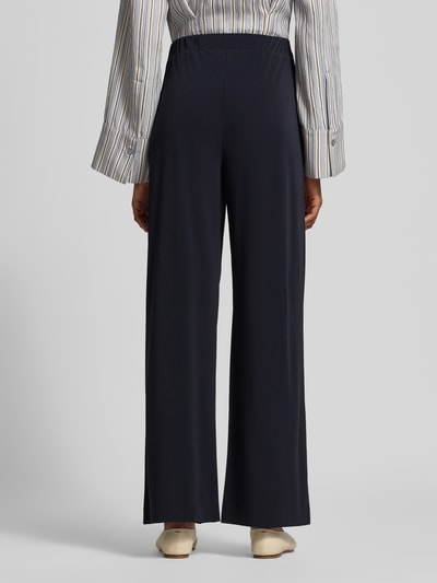 Vrouwenmodel draagt Relaxed Fit Stoffhose met Tunnelzug van MM by Max Mara in donkerblauw, Steekzakken, Bandwijdte maat S 34 cm, Binnenbeenlengte 78 cm, relaxed fit, comfortbroekdesign, riemlussen, Ganzkörperansicht Rückansicht.