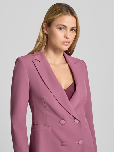 Vrouwenmodel draagt Blazer met doppelter Knopfleiste van Rinascimento in lila, getailleerd met Reverskraag en paspelzakken, Nahaufnahme Oberkörper. Ruglengte bij maat S: 64 cm.