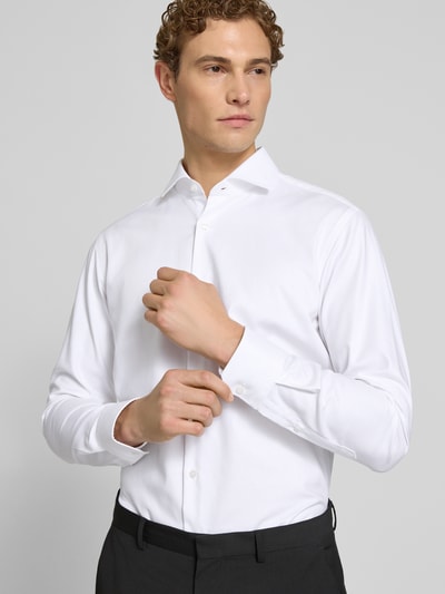 Männermodel trägt Regular Fit Businesshemd aus Baumwoll-Mix Modell 'H-JOE-SPREAD' von BOSS, Optik: Unifarben, Nahaufnahme Oberkörper.