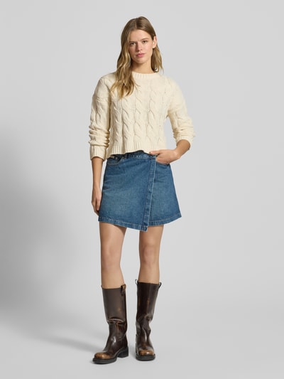 Vrouwenmodel draagt Regular Fit gebreide pullover met kabelpatroon Model 'ELLY' van Only, effen en gestructureerde look, korte lengte, ronde hals, lange mouwen, geribde boorden, strick verwerking. Ganzkörperansicht van voren.