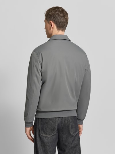 Männermodel trägt Jacke mit Reißverschluss von MCNEAL in Grau, Regular-Fit, Kentkragen, gerippte Abschlüsse, Rückenlänge 68 cm, Ganzkörperansicht Rückansicht.