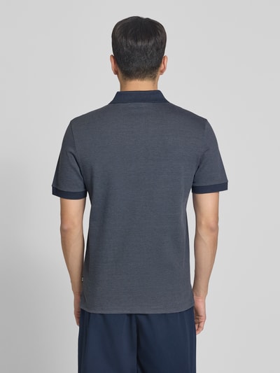 Męski model nosi Regular Fit Poloshirt aus reiner Baumwolle Modell 'H-PARLAY 102' von BOSS, efekt: dwukolorowy, krój regular fit, kołnierzyk polo, krótkie zapięcie na guziki, krótki rękaw, wykończenie z rozcięciami po bokach, wykonany z bawełny, odcienie granatu i szarości, widoczna tekstura materiału, całkowity widok z tyłu.