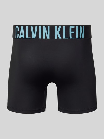 Produktfoto, Trunks mit elastischem Bund im 3er-Pack von Calvin Klein Underwear in Schwarz mit blauem Logo-Bund, Material-Mix mit Stretch-Anteil, körpernahe Passform.