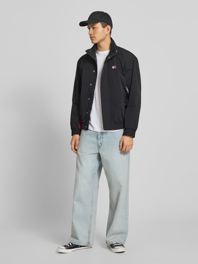 Männermodel trägt Regular Fit Blouson mit Logo-Stitching von Tommy Hilfiger, Optik: Unifarben, Satin, Ganzkörperansicht von vorne.