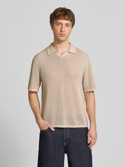Männermodel trägt Regular Fit Strick-Poloshirt Modell 'CASSIS' von Jack & Jones aus reiner Baumwolle, V-Ausschnitt, beige, Ganzkörperansicht von vorne.
