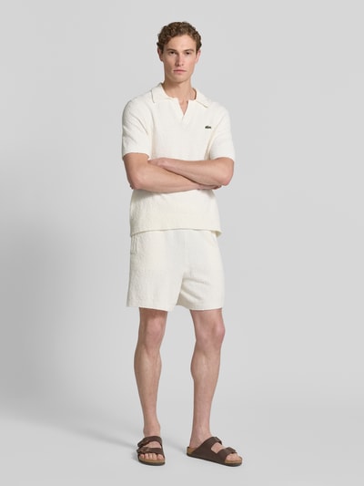 Männermodel trägt Relaxed Fit Sweatshorts aus Baumwoll-Mix von Lacoste, unifarben, Label Patch, elastischer Bund, Bouclé-Struktur, Ganzkörperansicht von vorne.