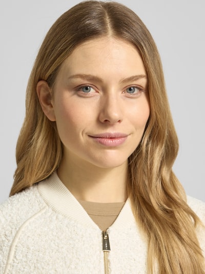 Vrouwenmodel draagt Regular Fit Jacke met viscose van comma, gebroken wit, mix van viscose en katoen, staande kraag, ritssluiting, elastische boorden, detailopname gezicht en bovenlichaam